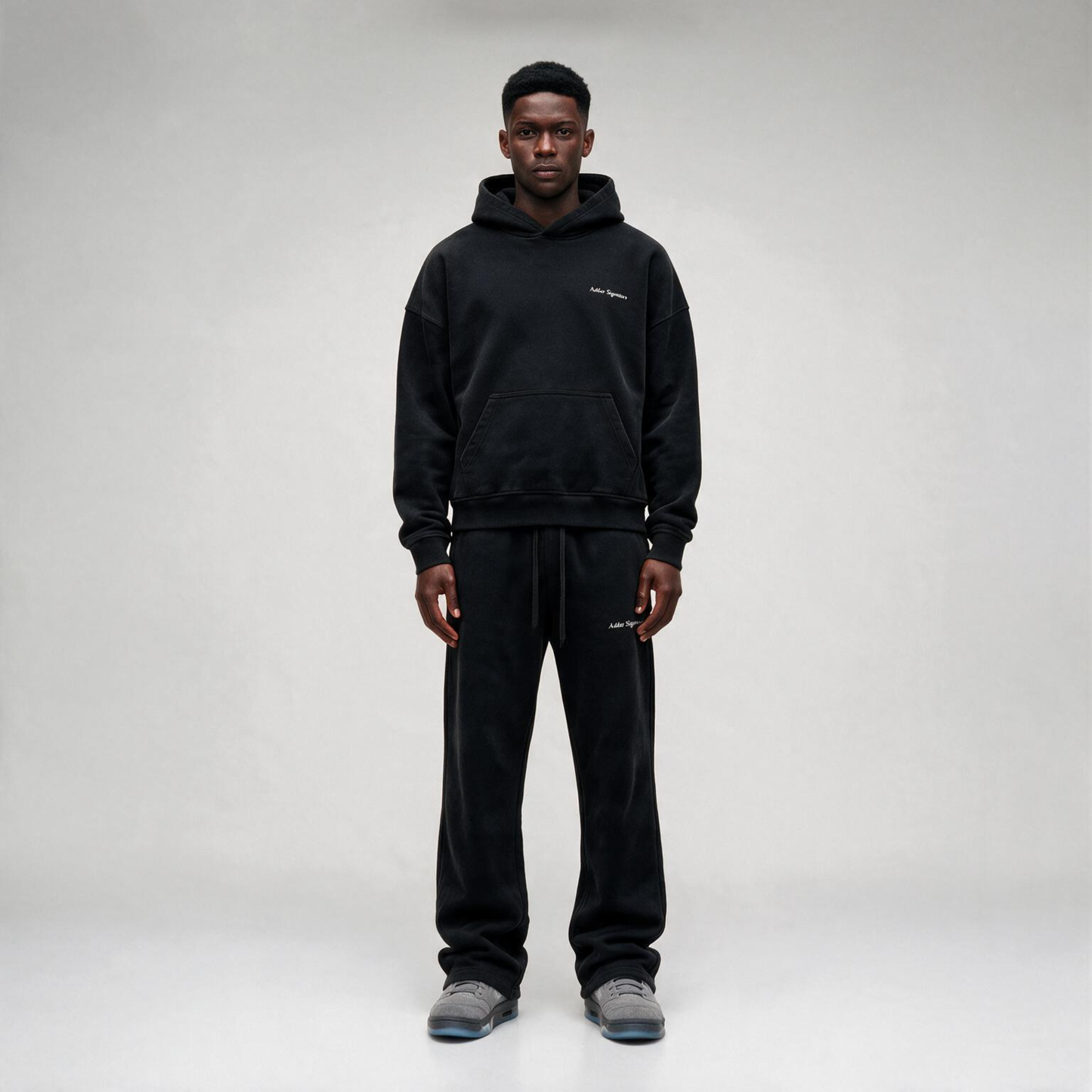 Black hoodie featuring a matching white "SIGNATURE"