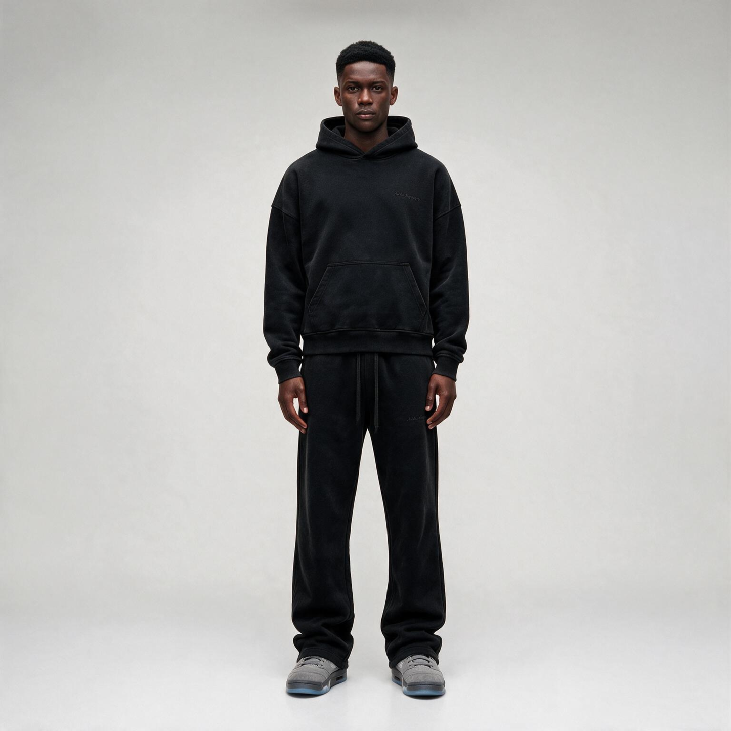 Black Hoodie with a tonal "SIGNATURE" print on the back and an oversize.