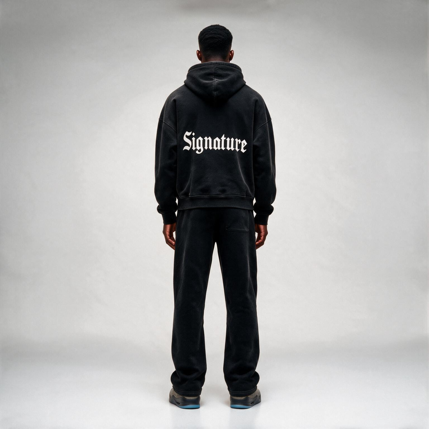 Black hoodie featuring a matching white "SIGNATURE"
