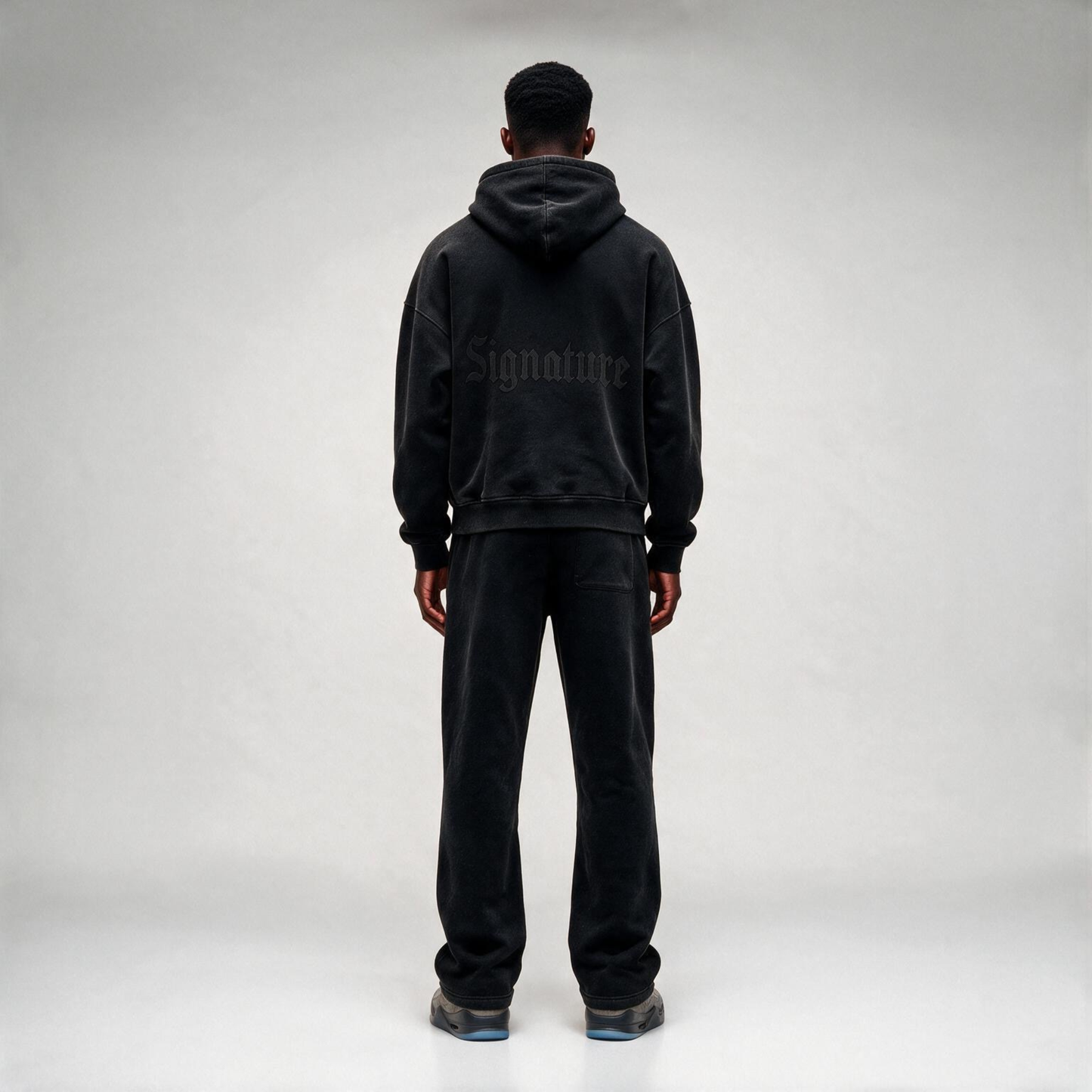 Black Hoodie with a tonal "SIGNATURE" print on the back and an oversize.