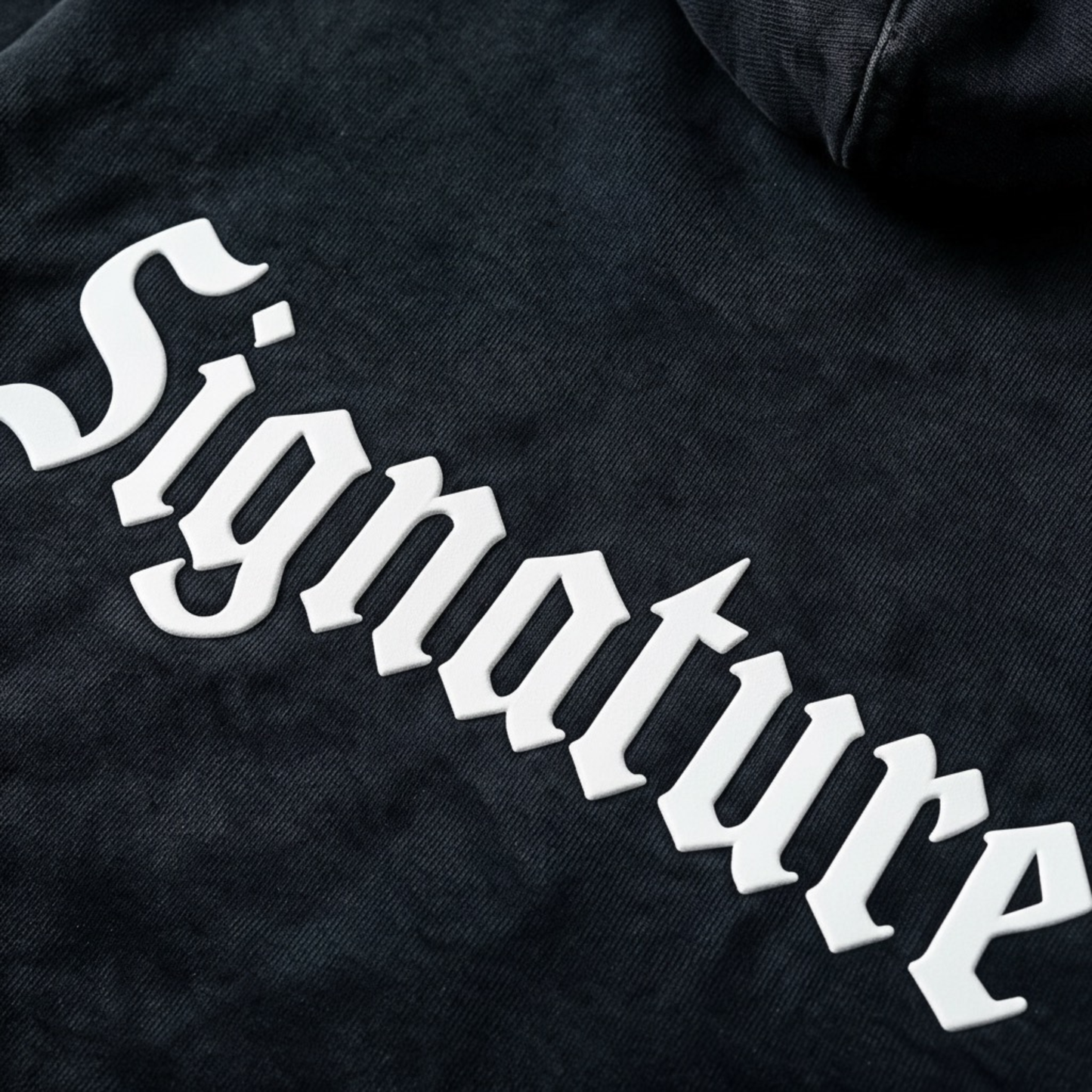 Black hoodie featuring a matching white "SIGNATURE"