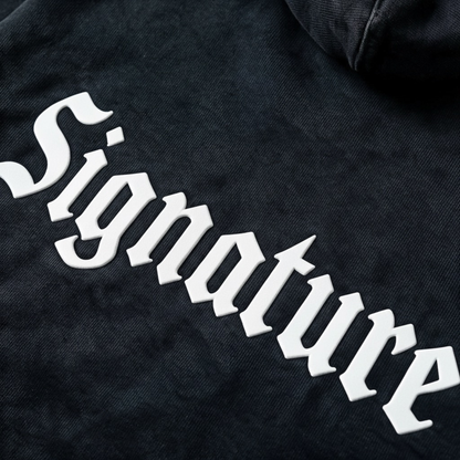 Black hoodie featuring a matching white "SIGNATURE"
